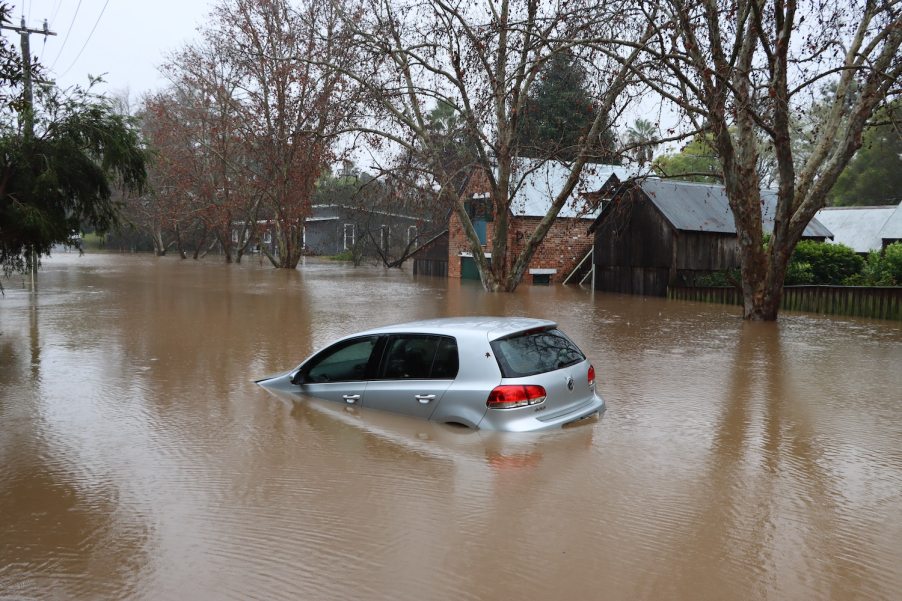 A silver VW car damaged in a flood