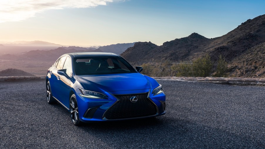 A blue Lexus ES 250 AWD parked outdoors near mountains