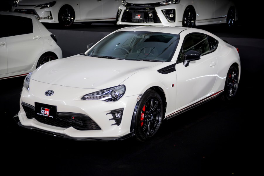 A white Toyota GR86 parked indoors.