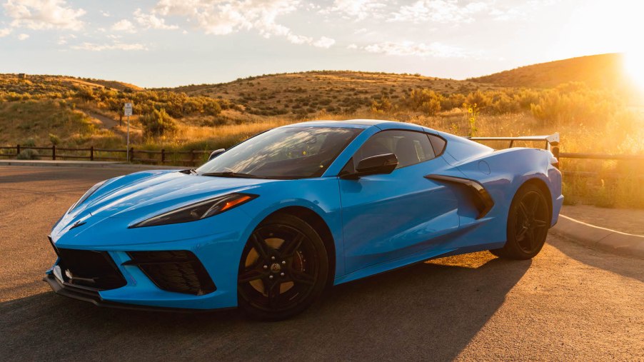 A blue 2022 C8 Corvette luxury sport coupe parked in the sun