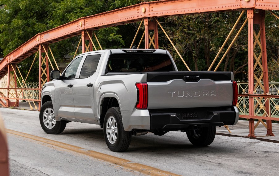 A silver, third generation Toyota Tundra parked on a bridge, facing away from the camera.