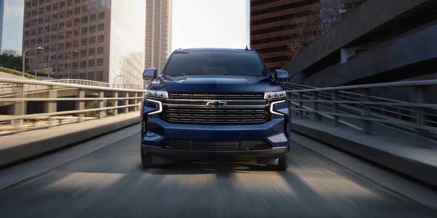 a blue 2023 chevy tahoe driving on a highway. Check out our guide to every trim level.