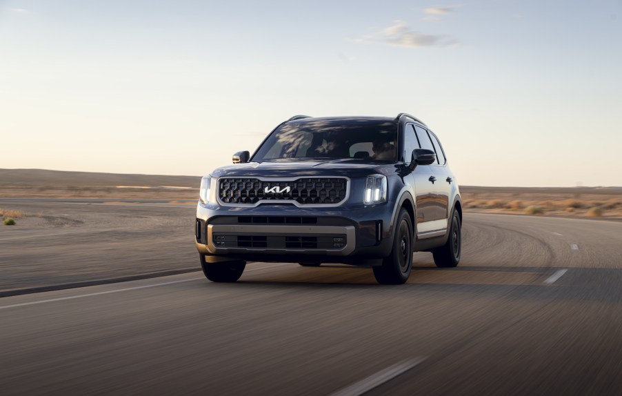 A 2023 Kia Telluride SUV driving at dusk