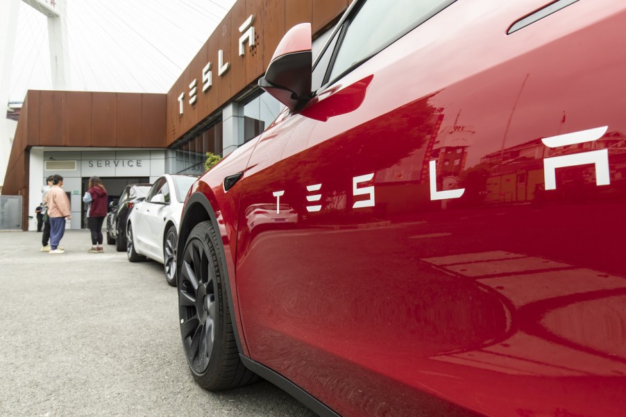 A red Tesla Model X, similar to the Model X stuck in a parking garage with the 'Always Sunny in Philadelphia' star