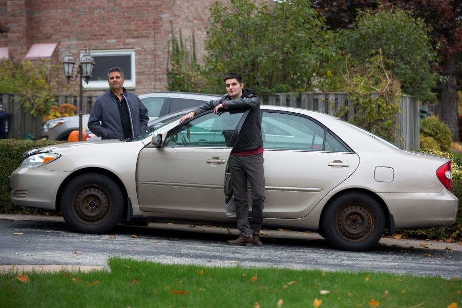 A father and son searching for auto insurance for an old Toyota car in Toronto, Ontario, Canada