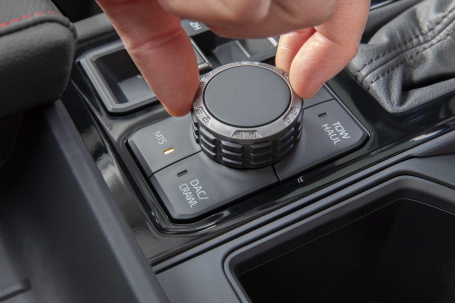 Closeup of a driver's hand spinning the MTS knob on a Toyota pickup truck.