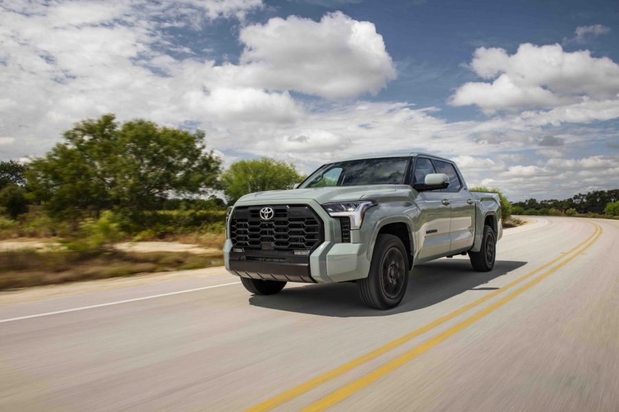 A silver 2022 Toyota Tundra driving down the road.