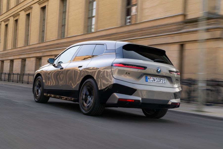 A 2023 BMW iX driving down a city street