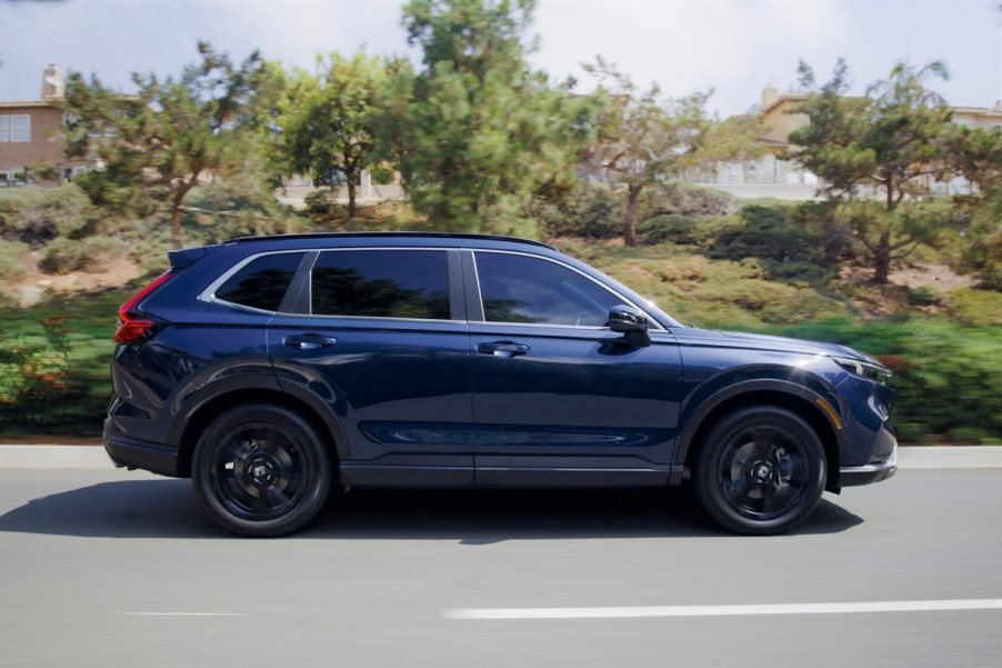 A blue 2023 Honda CR-V driving down the road.