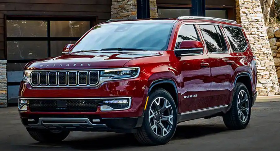 A red 2023 Jeep Grand Wagoneer large luxury SUV is parked.