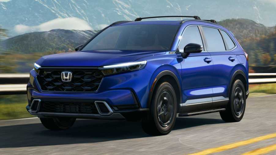 The 2023 Honda CR-V Hybrid driving down the road