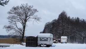 An RV parked in the snow that could use an electric heater in the RV.