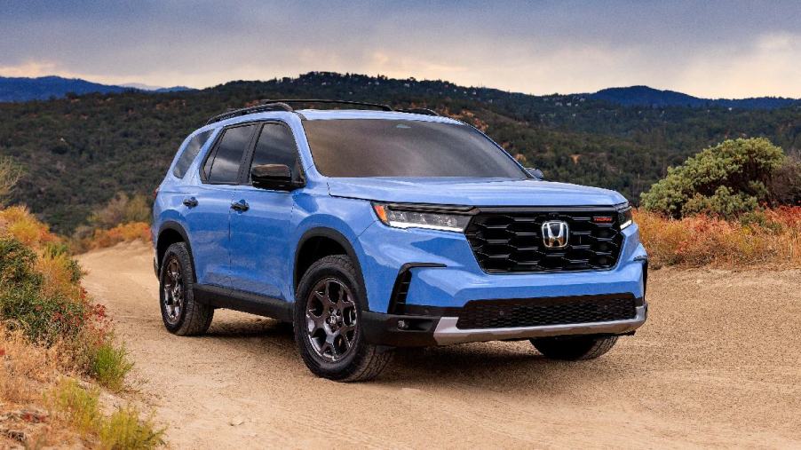 Front angle view of blue 2023 Honda Pilot midsize SUV