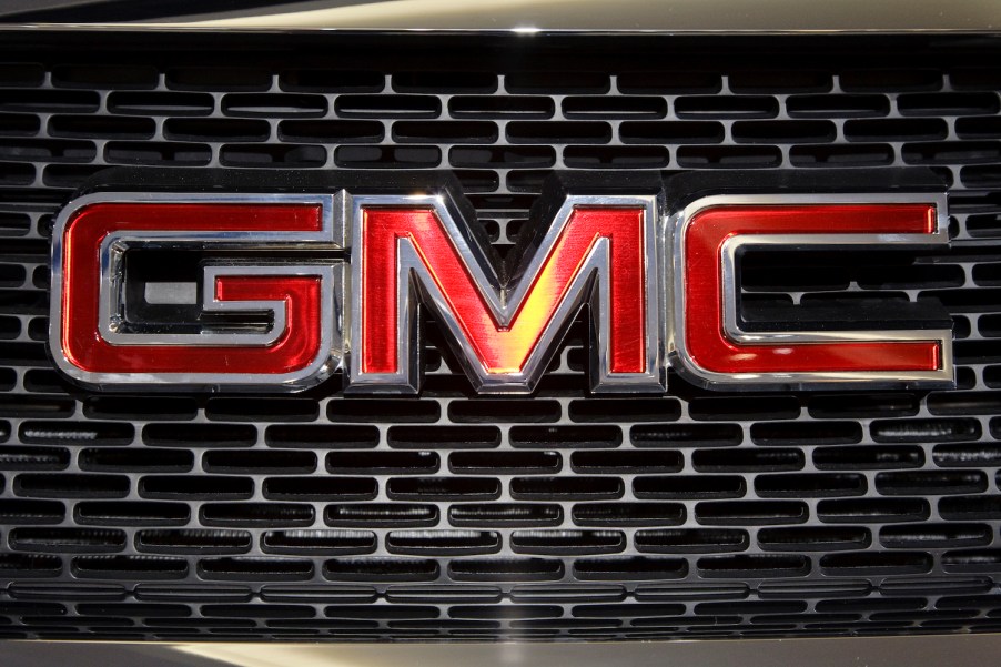 Closeup of a classic General Motors Company GMC logo on the grille of a truck at an auto show.