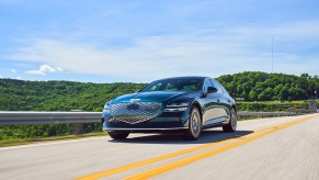 A Genesis Electrified G80 driving down the road. The G80 is one of the better Genesis sales stories from 2022.