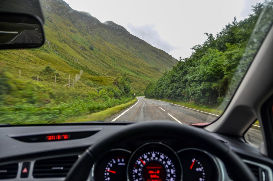 A driver's view while driving down the road.