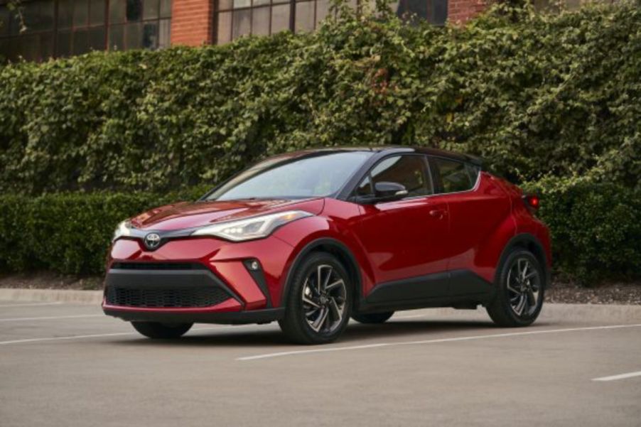 A red Toyota C-HR in a parking lot.