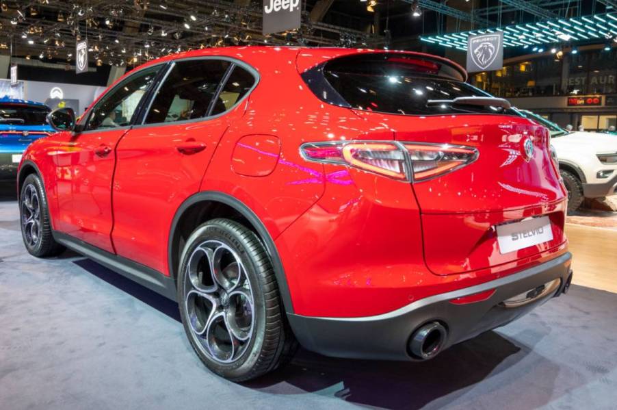 A red 2023 Alfa Romeo Stelvio on display at an auto show.