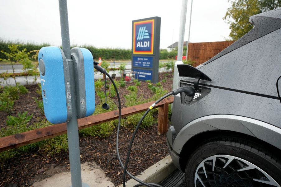 A Hyundai Ioniq 5 electric vehicle (EV) plugged into a charging station at an Aldi supermarket/grocery store