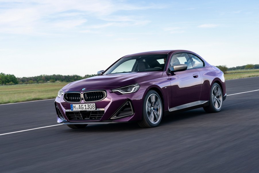 A purple BMW 230i on a track