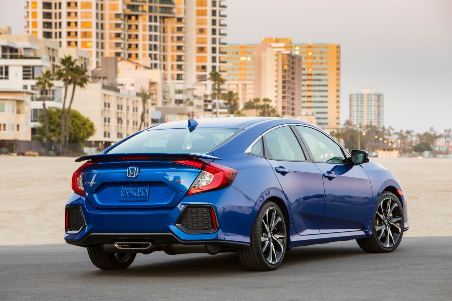 A used Honda Civic shows off its four-door car styling on a beach.