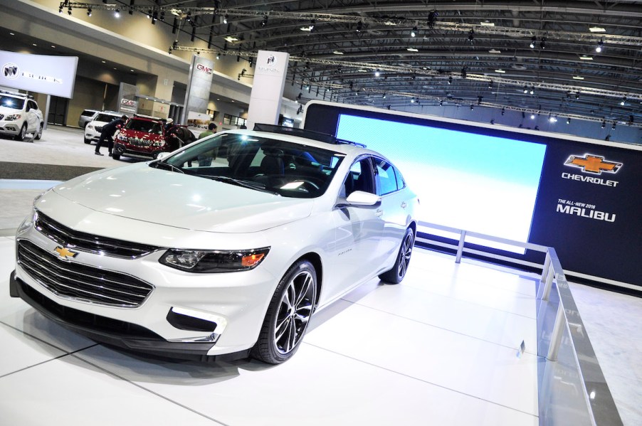 A white 2016 Chevy Malibu parked indoors.