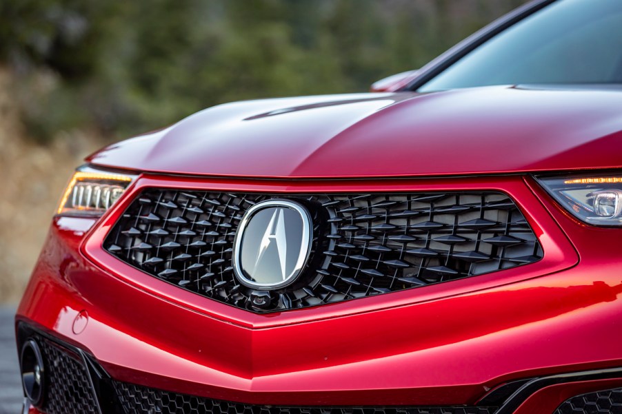 The front grille of a red 2020 Acura TLX.