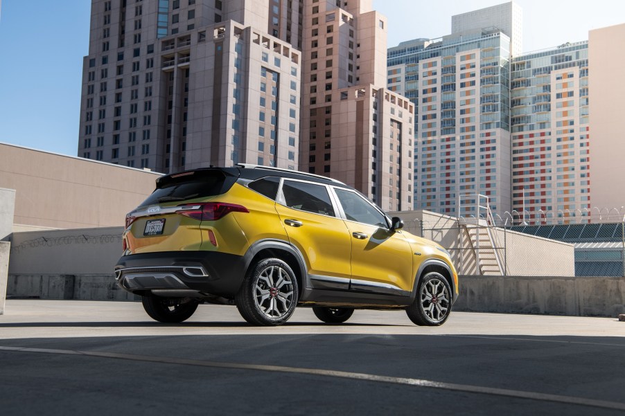 The 2023 Kia Seltos is a cheap AWD car with compact SUV styling, like this one in front of a city skyline.