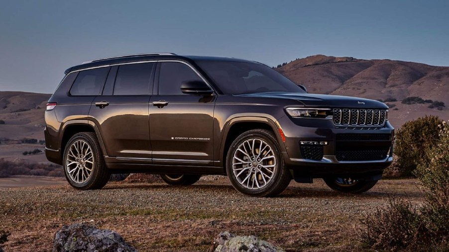 Front angle view of brown 2023 Jeep Grand Cherokee midsize SUV