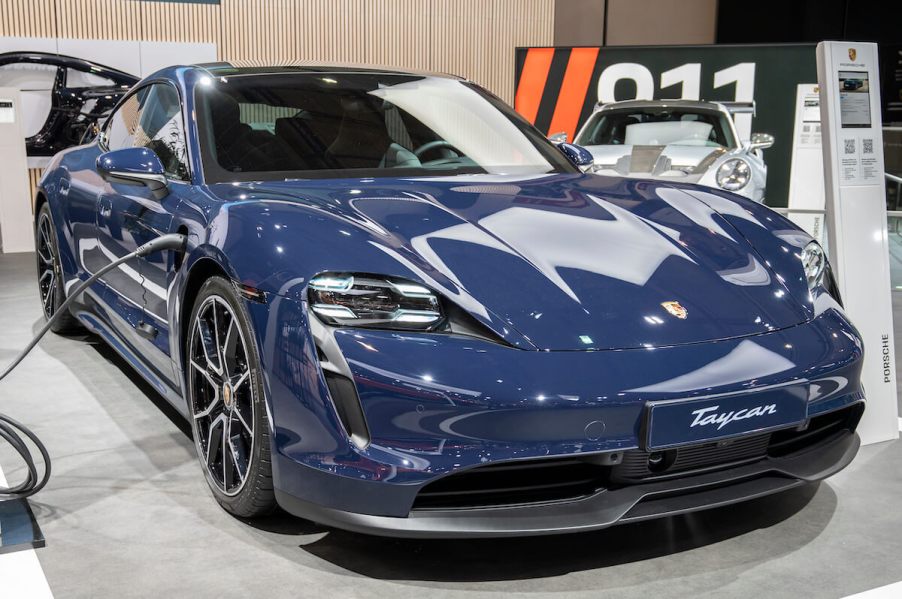 A blue Porsche Taycan parked indoors.