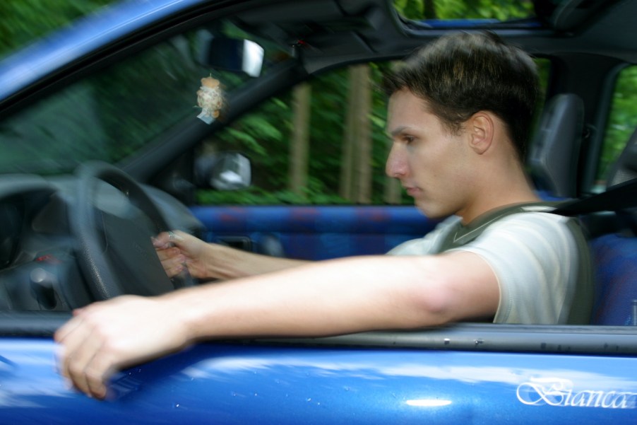 A young man in sleepy in his car.