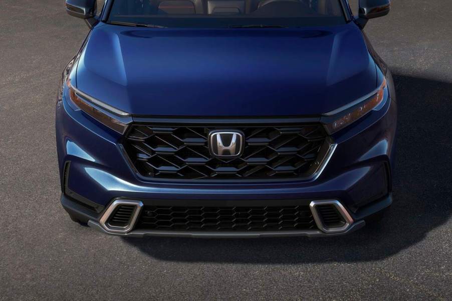 A blue 2023 Honda CR-V parked on a blacktop ground. Honda CR-V owners have a few things they like and dislike about their vehicle.