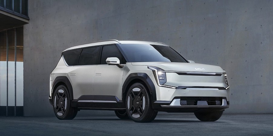 A white 2024 Kia EV9 midsize electric SUV is parked.