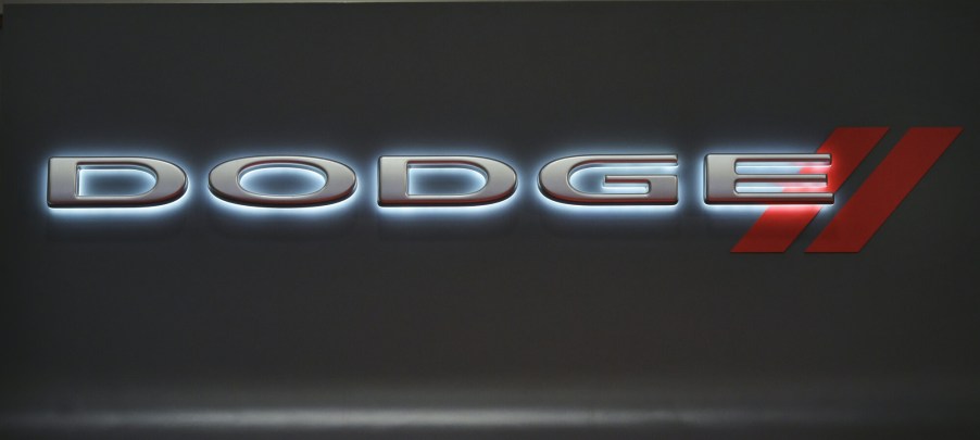 A backlit Dodge logo on a black background.