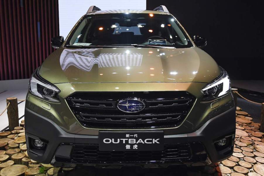 A green Subaru Outback parked indoors. The Outback is one of the best Subaru SUVs to buy.