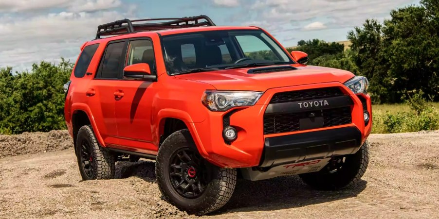 An orange 2023 Toyota 4 Runner is parked.