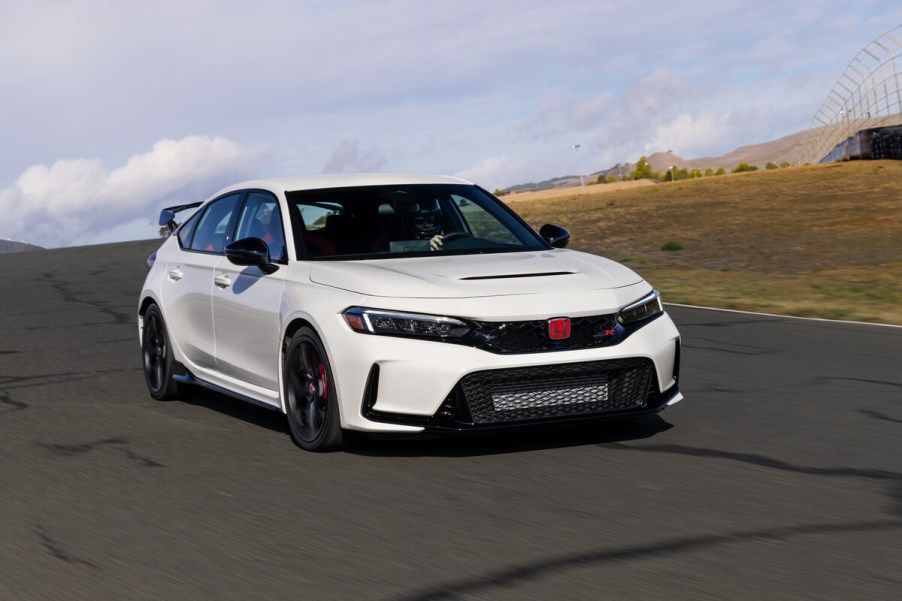 A white 2023 Honda Civic Type R hot hatch car corners on a track.