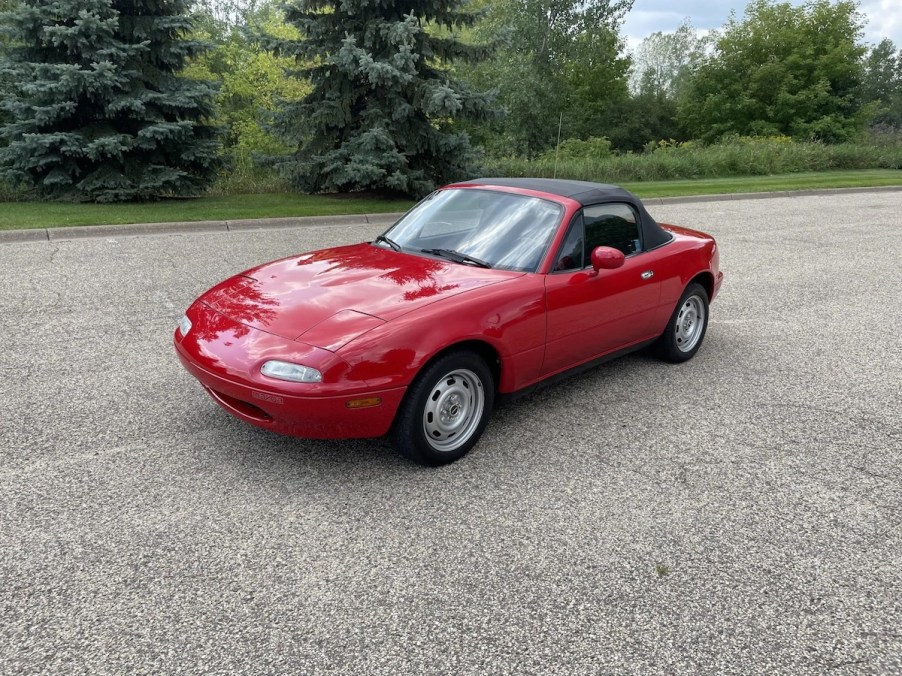 The pristine red 1990 Mazda Miata on Bring a Trailer