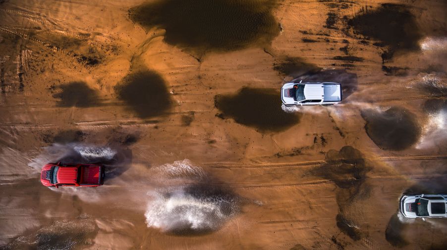 Three 2023 F-150 Raptor Rs mobbing through the desert