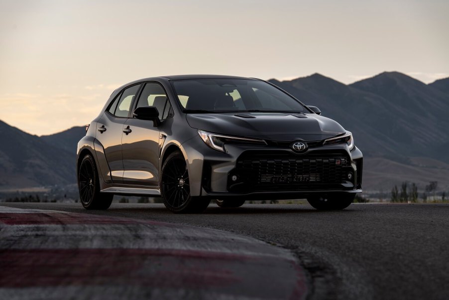 A dark gray Toyota GR Corolla shines on a test track.