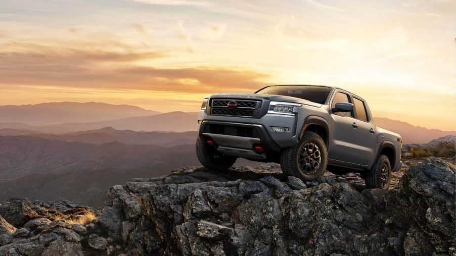 A 2023 Nissan Frontier midsize truck sits on a rocky outcrop.