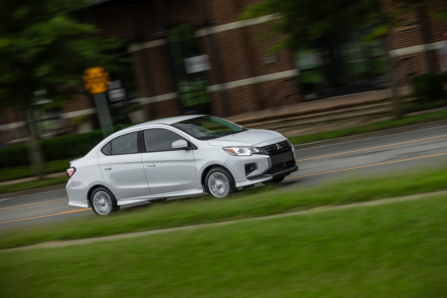 A silver Mitsubishi Mirage G4 driving on a city street