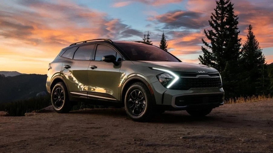 Front angle view of green 2023 Kia Sportage Hybrid compact crossover SUV