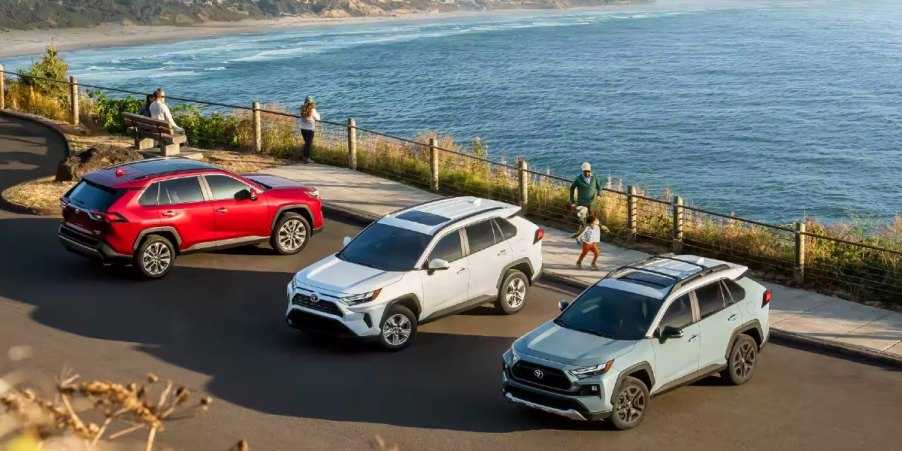 Three Toyota RAV4 small SUVs are parked.