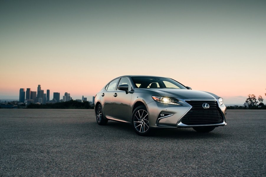 A 2018 Lexus ES 350 parks in a car lot ahead of a nice sunset in LA.