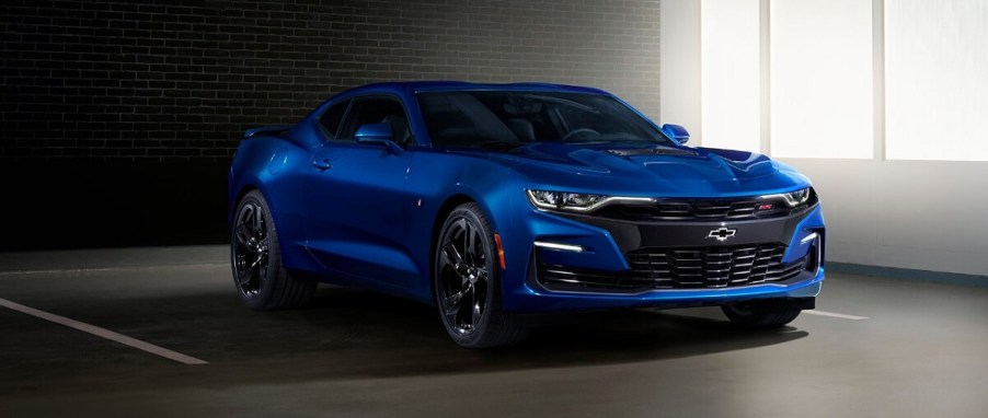 A blue 2019 Chevrolet Camaro parks in a garage.