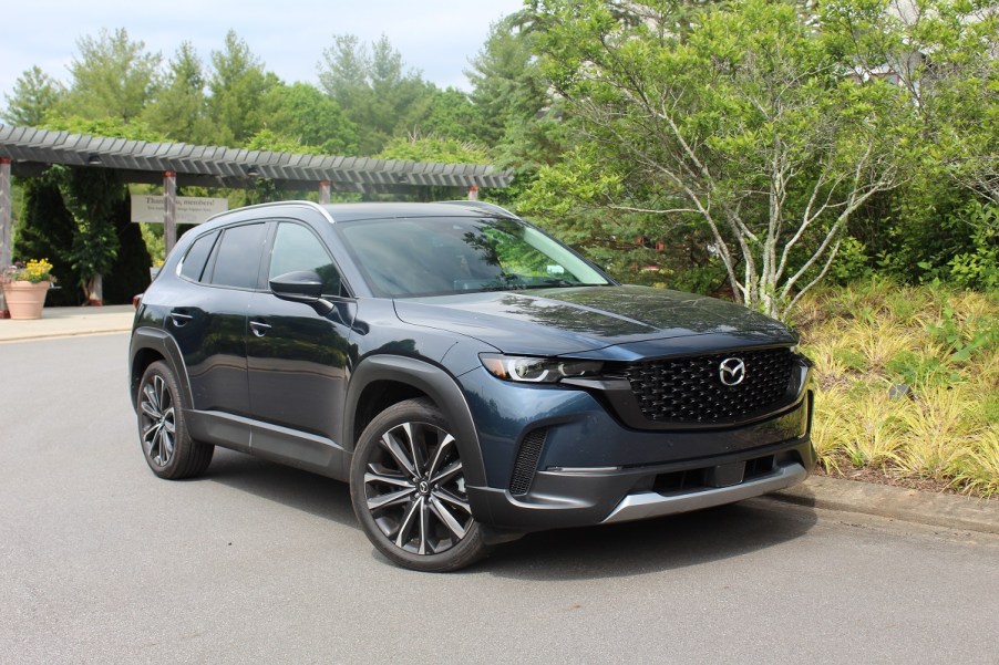 The 2023 Mazda CX-50 parked near foliage