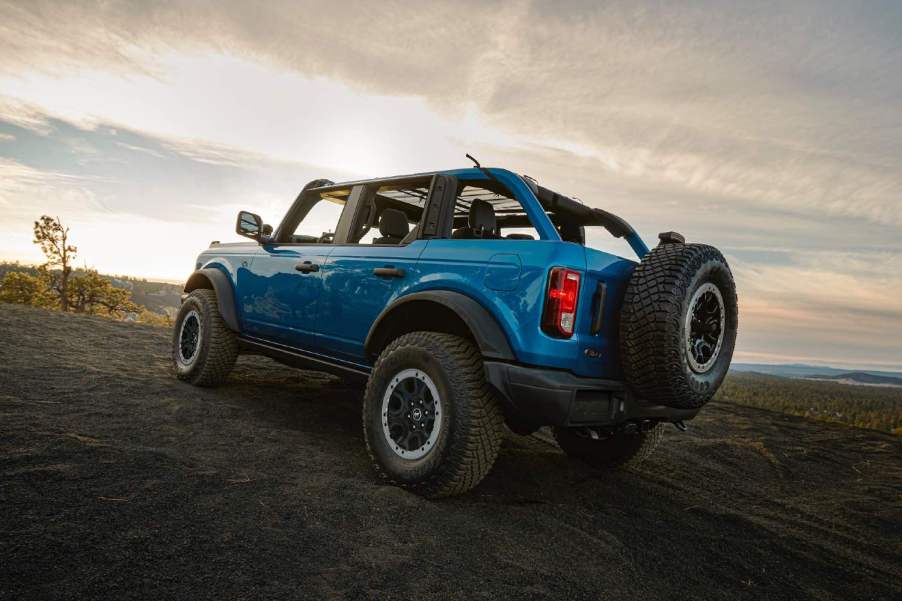 A blue 2023 Ford Bronco driving off-road.