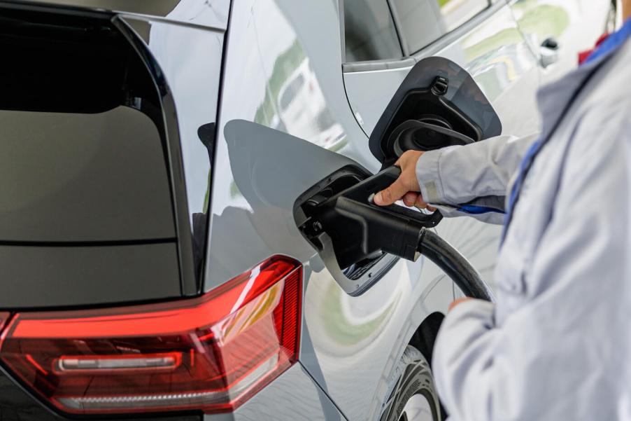 A worker demonstrates the EV charging process of Volkswagen's second generation ID.3 electric car