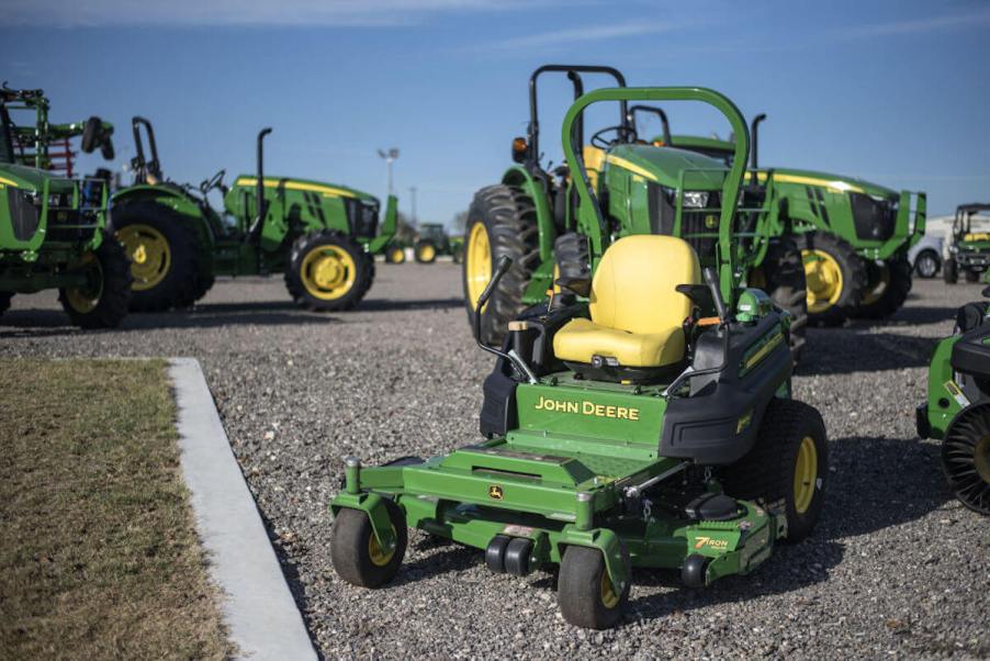 John Deere tractors sitting on asphalt